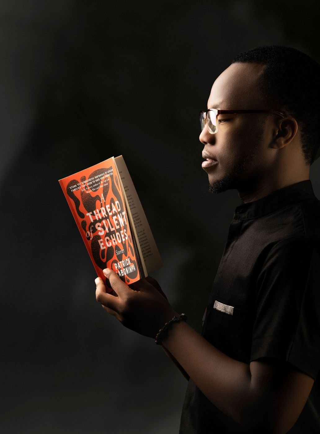 Patrick holding the book in profile