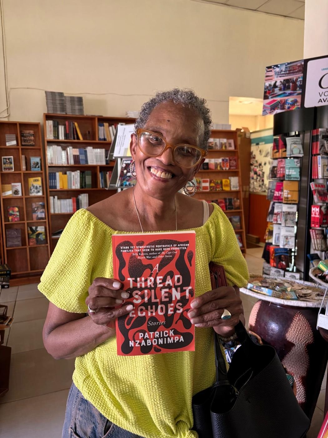 A reader holding the book in a bookshop