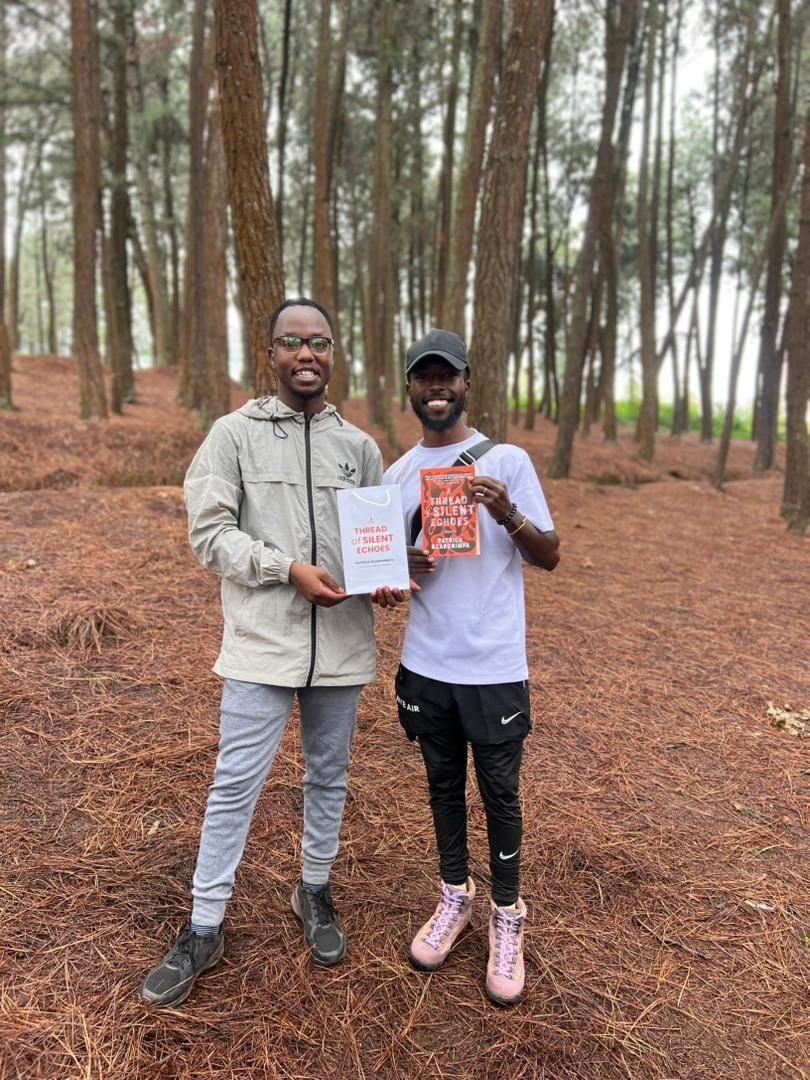Two readers with the book in a pine forest