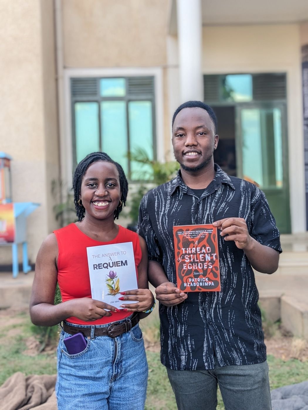 A reader with the book, beside a friend with The Answer to a Requiem